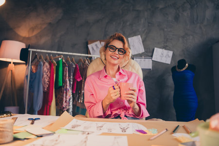 Portrait of nice young clothing designer lady hold coffee wear shirt loft interior office indoorsの写真素材