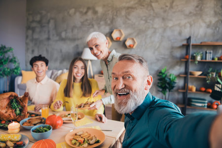 Photo of four relatives family have fun make selfie gather celebrate thanksgiving dinner apartment indoorsの写真素材