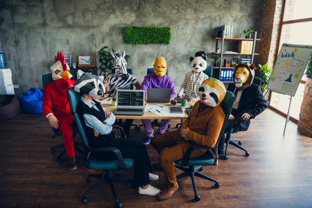 Photo of panda rooster gorilla lion sloth zebra raccoon mask people desktop meeting loft interior...