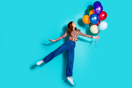 Full size photo of attractive young woman hold air balloons flying dressed stylish colorful clothes...