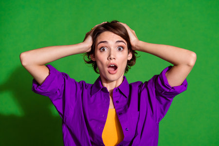 Portrait photo of young upset confused girl brown haired touching head emotional day wear violet...