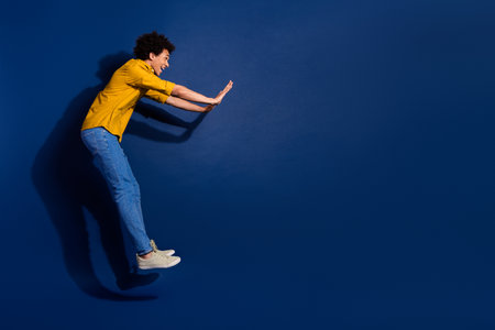 Full size photo of nice young man jump fall empty space isolated on dark blue color background