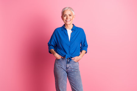 Photo of shiny attractive lady dressed blue shirt smiling empty space isolated pink color background