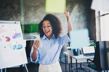 Photo of lucky good mood lady specialist dressed shirt winning game modern device indoors workstation workshopの写真素材