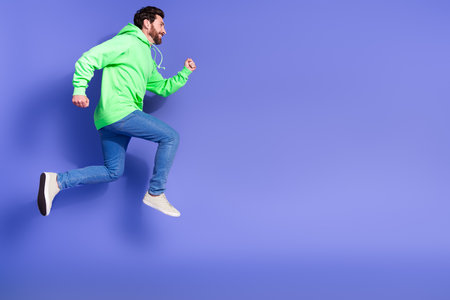 Full body photo of attractive young man running hurry empty space dressed stylish green clothes...