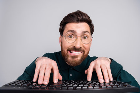 Photo of attractive nice excited man wear stylish clothes use modern device isolated on gray color backgroundの写真素材