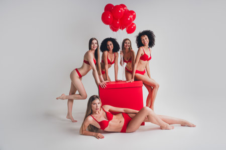 Full length photo of ladies people celebrate birthday balloons gift red lingerie white wall studio background no filter self acceptanceの写真素材