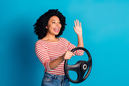 Photo of glad positive cheerful girl wear trendy clothes hold steering wheel empty space isolated on...