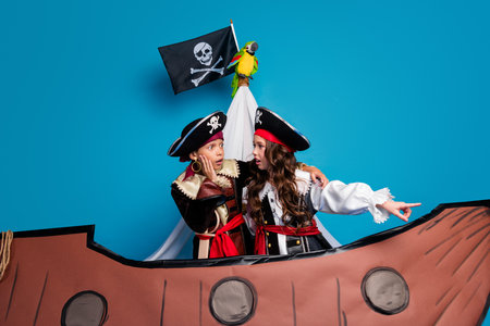 Photo of lovely two little kids amazed explorers lands dressed pirates costumes birthday party...