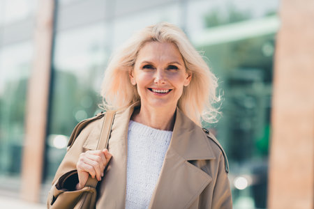 Photo of lovely cute adorable woman dressed stylish clothes walking city downtown enjoying sunny autumn weather dayの写真素材