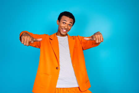 Photo of trend stylish guy point two fingers together advertising isolated cyan color backgroundの写真素材