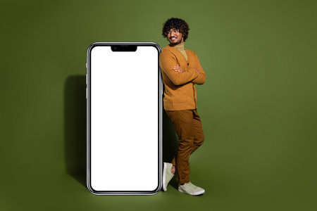 Full body photo of attractive young man crossed hands look big smartphone dressed stylish brown...