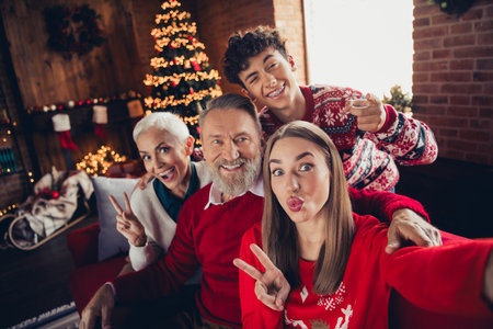 Portrait of big friendly family bonding take selfie show v-sign kiss lips xmas new year celebration flat indoorsの写真素材