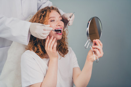 Photo of happy woman check smile after teeth cleaning braces and dental consultation professional...