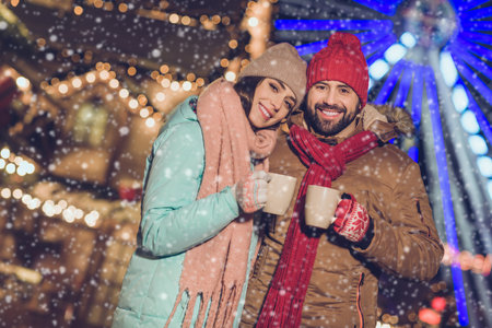 Photo of pretty shiny girlfriend boyfriend embracing enjoying hot beverage mugs outdoors urban city marketの写真素材