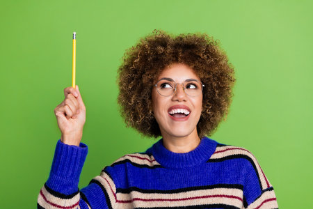 Photo of smart nerdy woman with perming coiffure wear knit sweater in glasses look at pencil in hand...