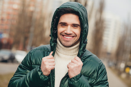 Photo of nice handsome smiling man wear trendy clothes walking on city street in cold day weather...