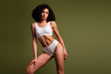 No filter photo of confident lovely woman wear stylish white comfortable lingerie empty space isolated on khaki color backgroundの写真素材