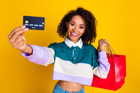 Photo portrait of attractive young woman hold shopping bags credit card dressed stylish striped...