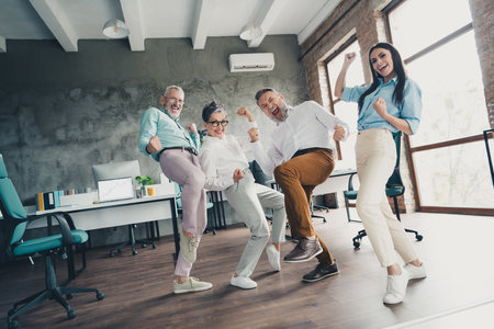 Full length low view photo of teamwork startup partners winning comfortable nice creative startup...