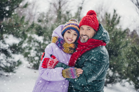 Photo of cute adorable wife husband dressed coats smiling embracing together walking outdoors urban...