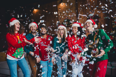 Photo of nice young people confetti good mood have fun enjoy cozy christmas decoration interior house indoors partyの写真素材