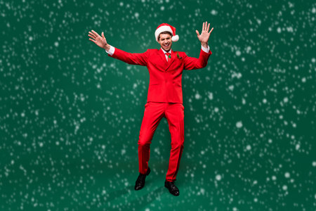 Full length body size view of attractive classy cheerful guy dancing having fun rest isolated over green color backgroundの写真素材