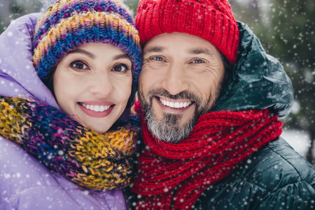 Photo of good mood pretty wife husband dressed coats embracing smiling enjoying time together outdoors urban forest parkの写真素材
