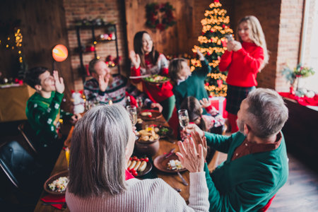 Portrait of big peaceful family phone make picture arm wave hi festive christmas x-mas time together flat indoorsの写真素材