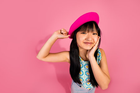 Photo of cute lovely girl wear trendy clothes isolated on pink color backgroundの写真素材