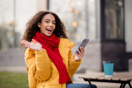 Photo of attractive cheerful positive girl wear coat cafe terrace drink hot latte cold autumn day outdoors outsideの写真素材