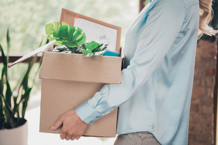 Cropped profile portrait of young business woman hold belongings box loft interior business center...