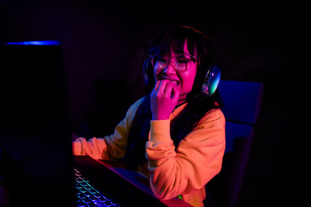 Photo of cute lovely nice girl nervous bite nails afraid play gamer computer laptop modern...