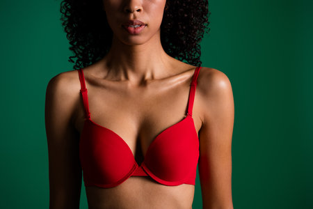 Cropped photo of shiny slim girl dressed red lingerie enjoy beautiful body empty space isolated green color backgroundの写真素材