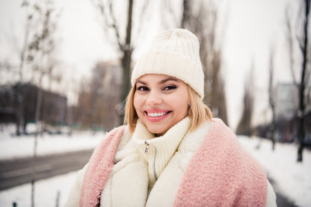 Portrait of positive cheerful girl smiling toothy enjoying x mas travel in big city megapolis winter...