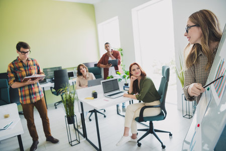 Photo of smiling thoughtful students enjoying business school studying listening important conference indoors workplace workstationの写真素材