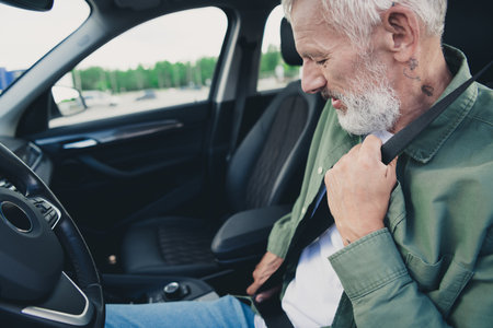 Photo of funky cool mature guy dressed casual shirt fasten auto saatbelt outdoors urban car parking