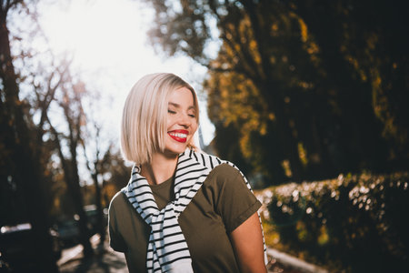 Photo of attractive young lady wondered cheerful smile wear khaki garment tied shoulders sweater...