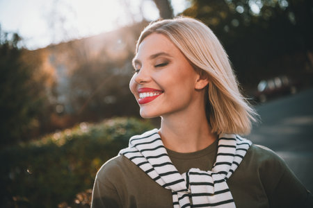 Photo of pretty young blonde woman dreamy smile wear khaki clothes tied shoulders sweater walk...