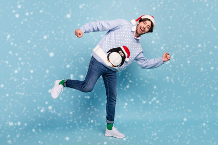 Full length photo of happy cheerful positive man good mood runner holiday sale isolated on blue color backgroundの写真素材