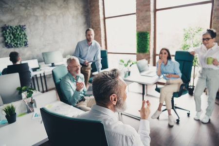 Full body photo of teamwork people working together meeting conference brainstorm comfortable modern office loft room interior workspaceの写真素材