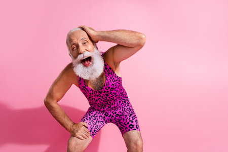 Photo of positive cheerful senior man wear stylish overall loud laughing isolated on pink color backgroundの写真素材