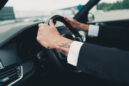 Senior businessman driving car, showcasing travel and business lifestyle with a focus on license and insurance conceptsの写真素材