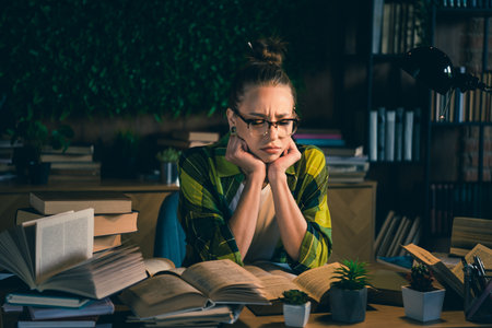 Young female student girl studying late in cozy home environment