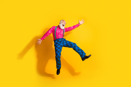 Full size photo of old gentleman dancing jump dressed glamour stylish outfit party isolated vibrant yellow color backgroundの写真素材