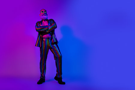 Full length photo of grandpa crossed hands dressed colorful sequins striped party clothes isolated on blue purple neon light backgroundの写真素材