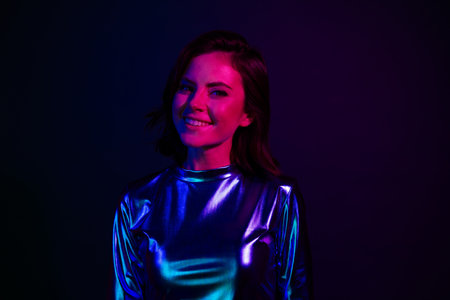 Photo portrait of attractive young woman look camera cheerful dressed stylish party retro clothes isolated on dark backgroundの写真素材