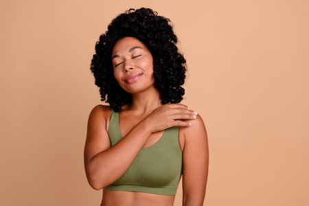 Studio no retouch photo of dreamy sensual lady dressed lingerie loving body positive empty space isolated ivory color backgroundの写真素材