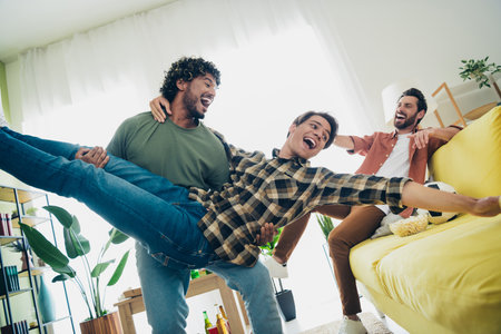 Portrait of three best friends arms hold throw sofa gather chill free time modern interior flat indoorsの写真素材