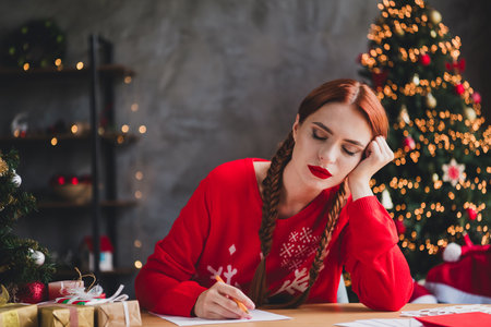 Portrait of nice young woman fell asleep write letter wear sweater new year xmas time flat indoorsの写真素材